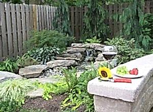 A natural looking waterfall completes the landscaping of this backyard