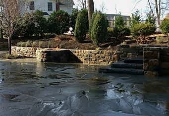 Fire pit built into the wall with new plantings above in this Basking Ridge NJ Landscape, completed by Landscape Designer GA Landscape Design
