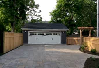 A paver driveway with wood fencing complete this Summit NJ Landscape Design