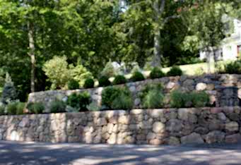 Stacked Stone Walls with plantings make for an inviting landscape design