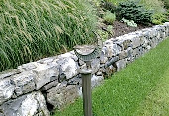 Moss Rock Stone Wall with new plantings create scenic landscaping