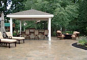 A Pavillion with an outdoor kitchen and a seating area with a fire pit complete the backyard living space in this Basking Ridge NJ backyard landscape