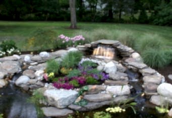 Scotch Plains NJ Landscape Lighting lights up a waterfall and pond in this NJ backyard